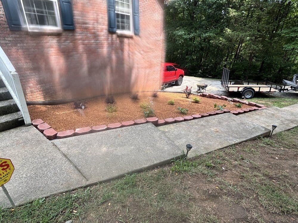 New bushes and tree with pea gravel in a new bed